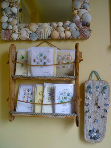 A selection of cards decorated with native Mull flowers or bits and bobs garnered on the seashore for sale.